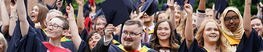 Graduates waving cap in air